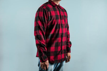 Man wearing a red and black checkered long sleeve shirt with jeans